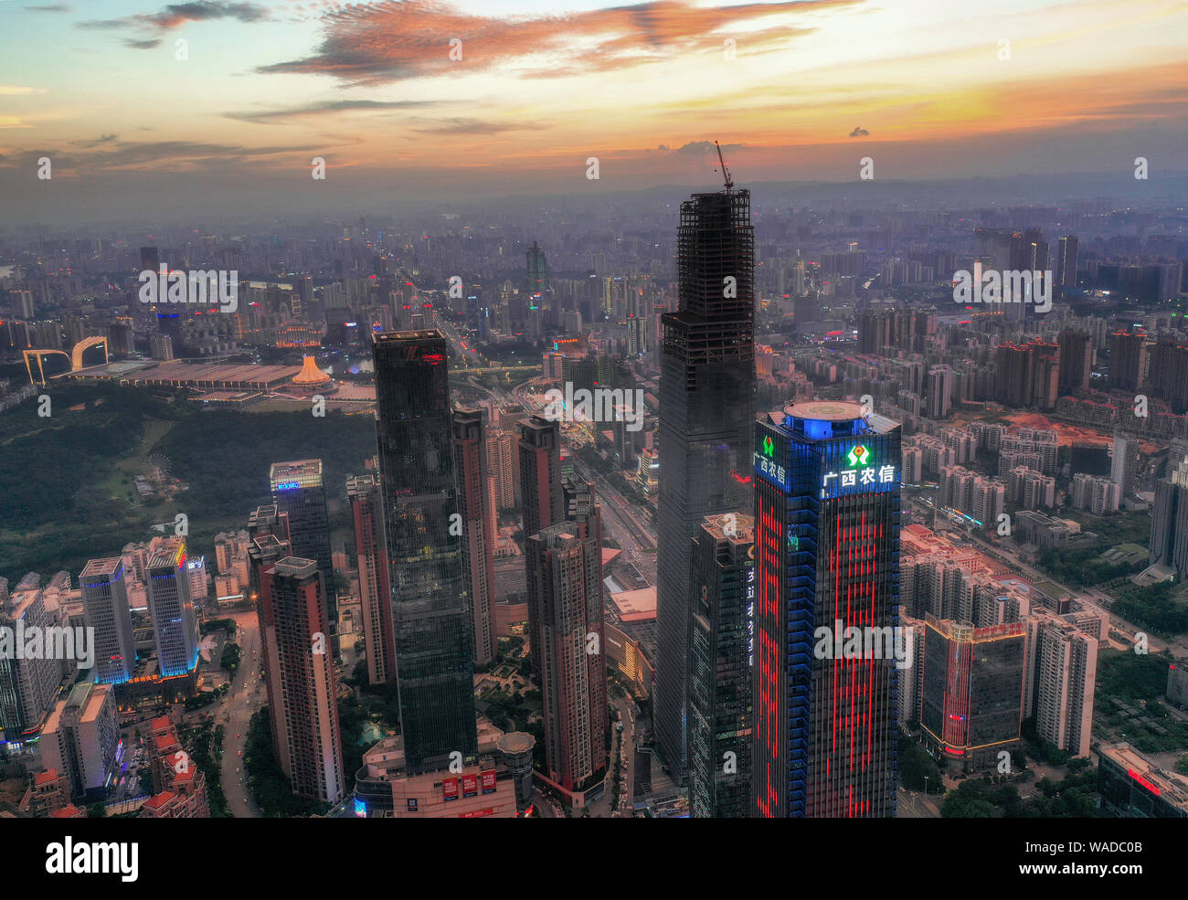 Skyline of skyscrapers and high-rising buildings at sunset in Nanning city, south China's Guangxi Zhuang Autonomous Region, 28 July 2019. South China' Stock Photo