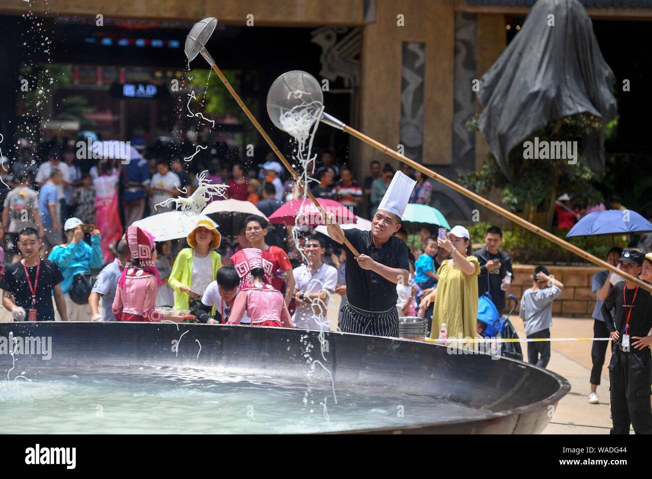Chefs get the rice noodle delivered by a Chinese entertainer dressed in