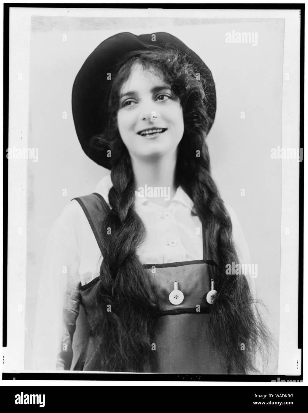 Dorothy Bernard, half-length portrait, in costume of jumper, hat, and braids Stock Photo