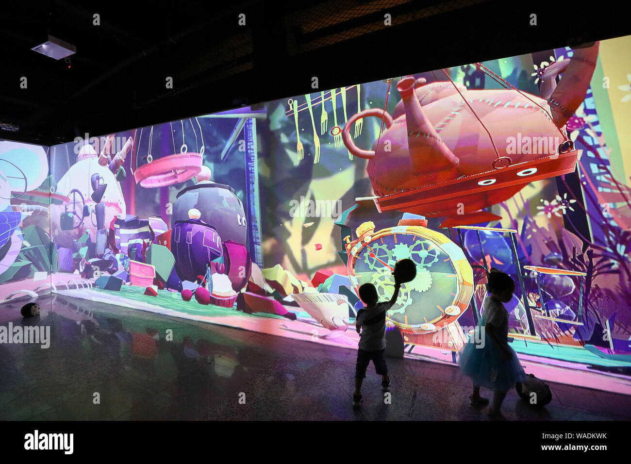 Children view an immersive digital art exhibition 