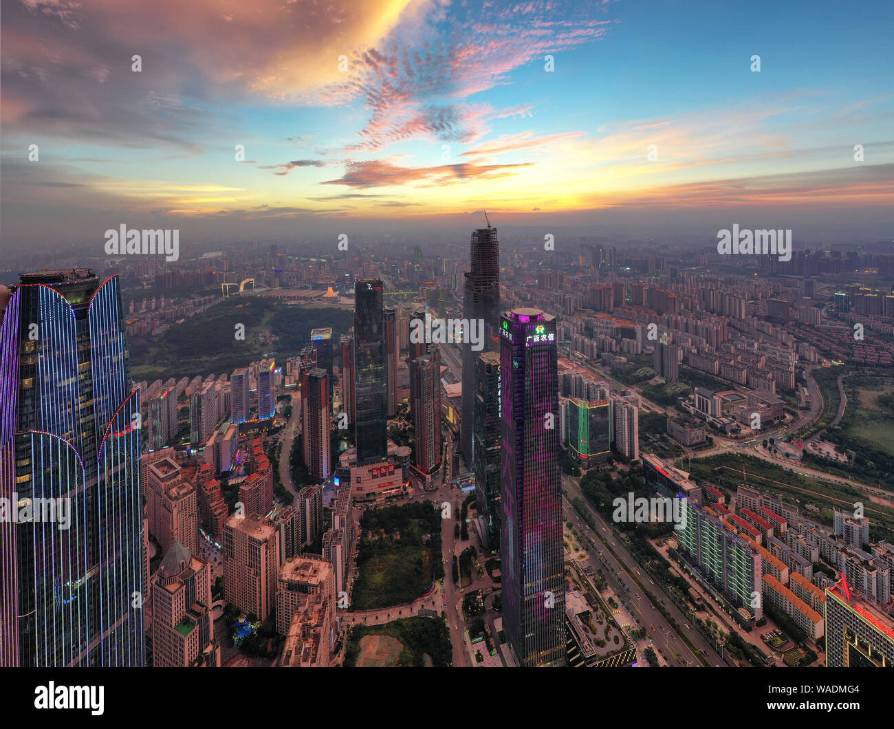 Skyline of skyscrapers and high-rising buildings at sunset in Nanning city, south China's Guangxi Zhuang Autonomous Region, 28 July 2019. South China' Stock Photo