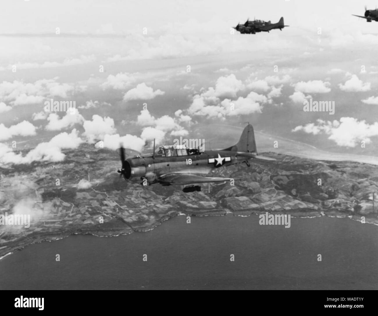 Douglas SBDs of Bombing Squadron 16 in flight over Saipan on 15 June 1944. Stock Photo