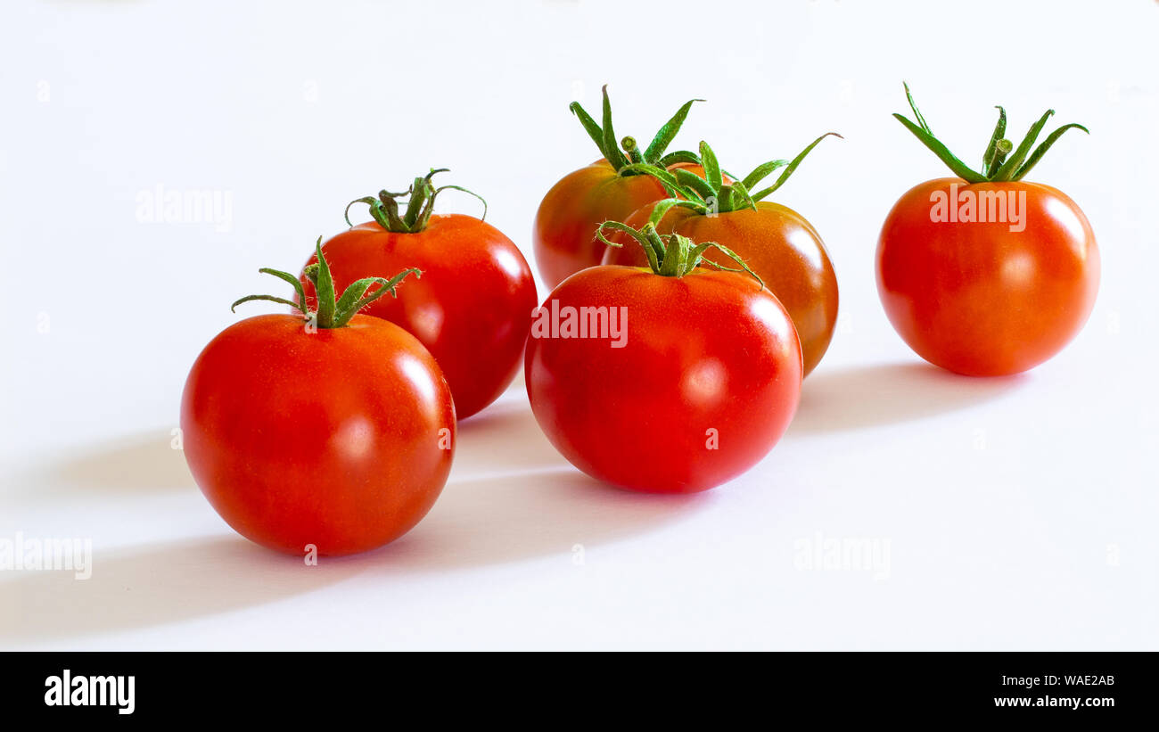 small red cherry tomatoes on white background Stock Photo - Alamy