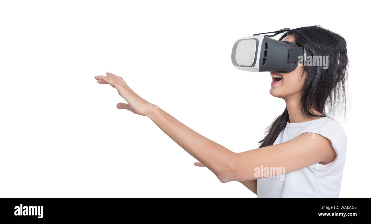 Asian girl using VR box google 3D Virtual Reality Glasses headset, against white background, She amazed of what she see Stock Photo