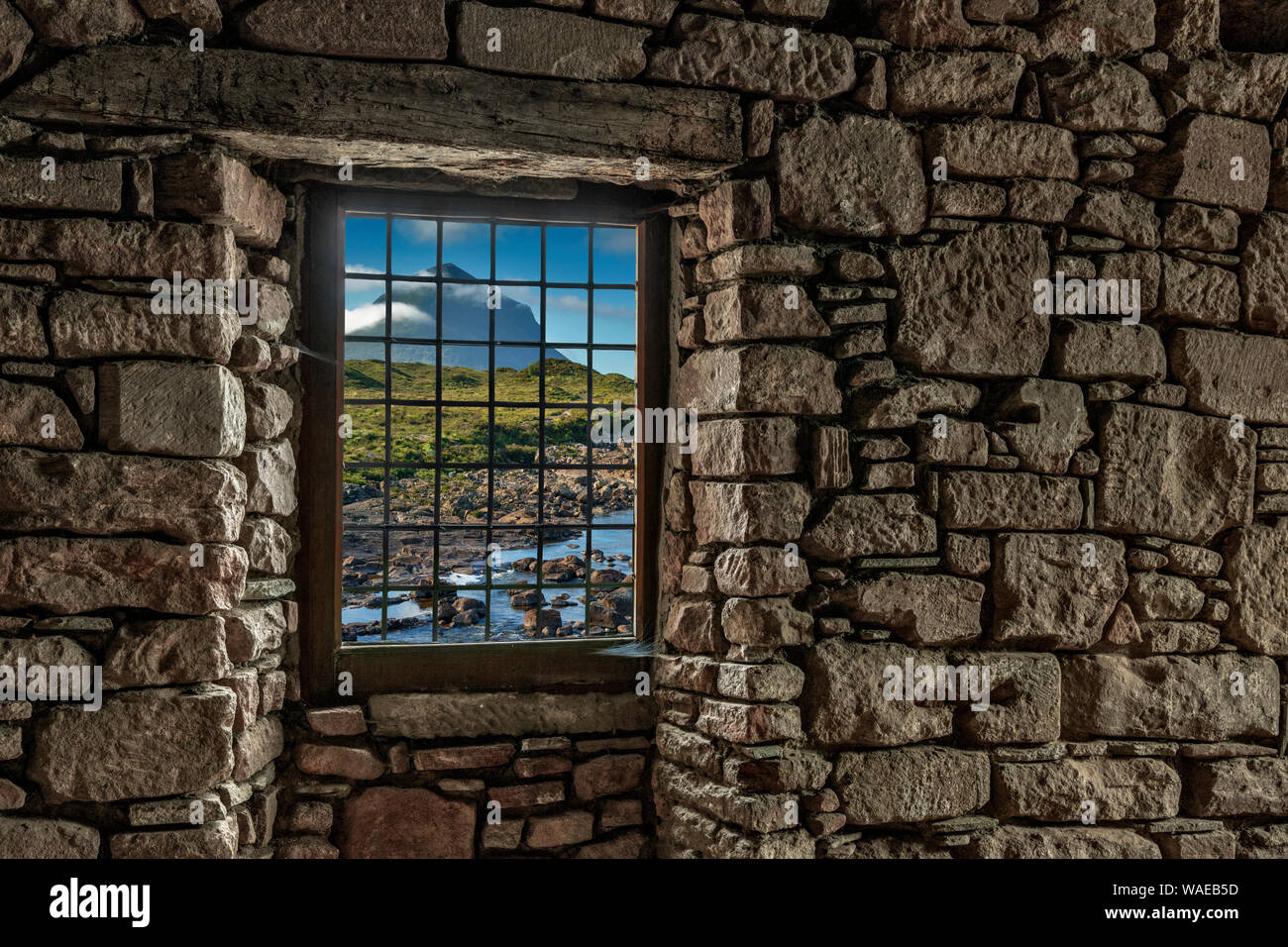 Looking through a window in a stone wall to the Isle of Skye, Scotland Stock Photo