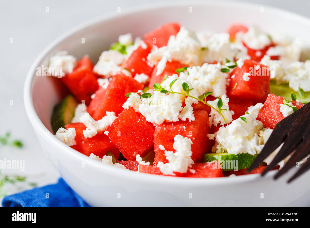 Watermelon, cucumber and feta cheese salad in a white bowl. Stock Photo