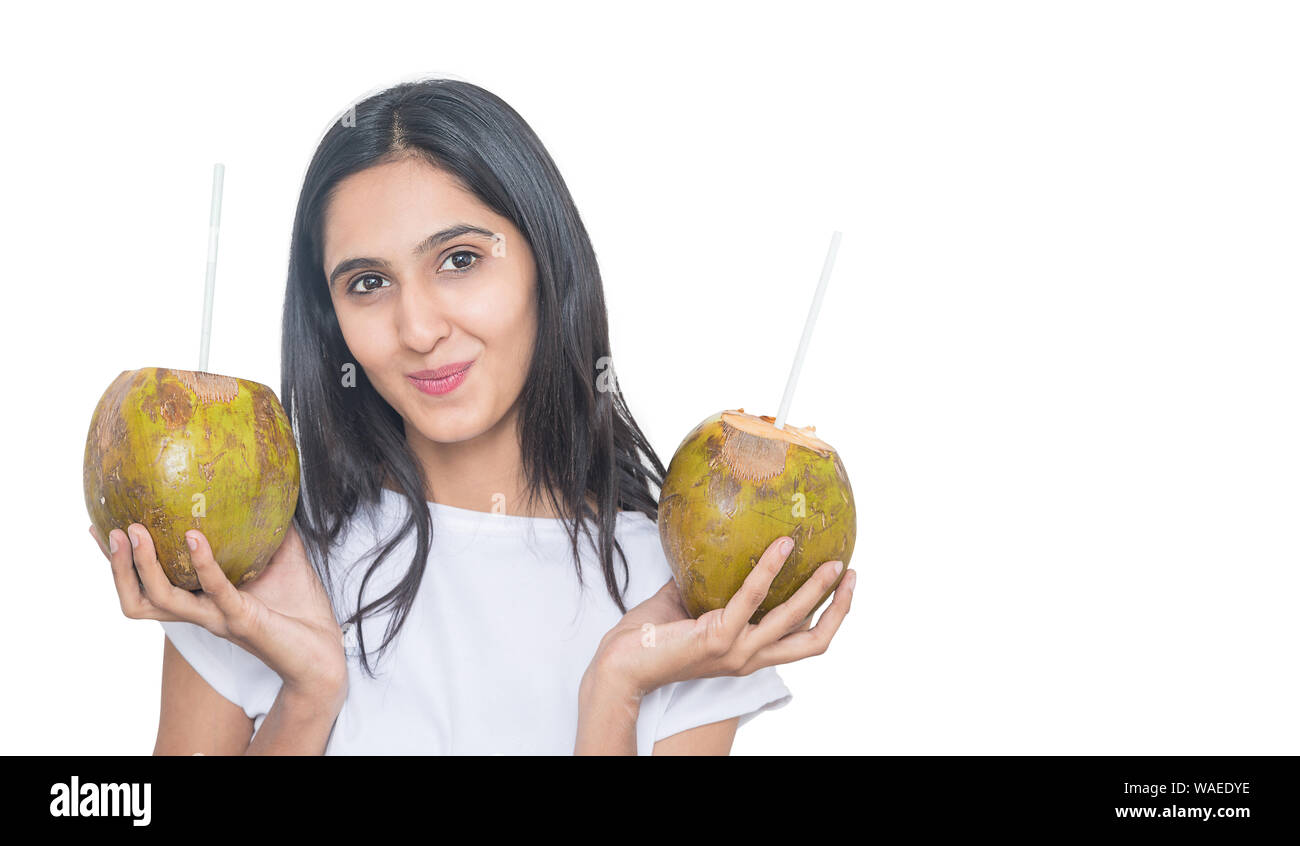 Young asian girl holding two fresh coconut water with straw Isolated on
