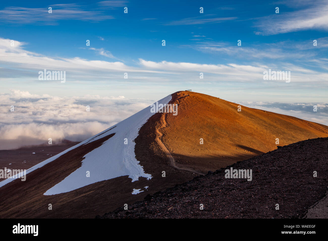 Native Hawaiian Shrine (Heiau) and its visitors atop a summit cone on Mauna Kea, Hawaii Stock Photo