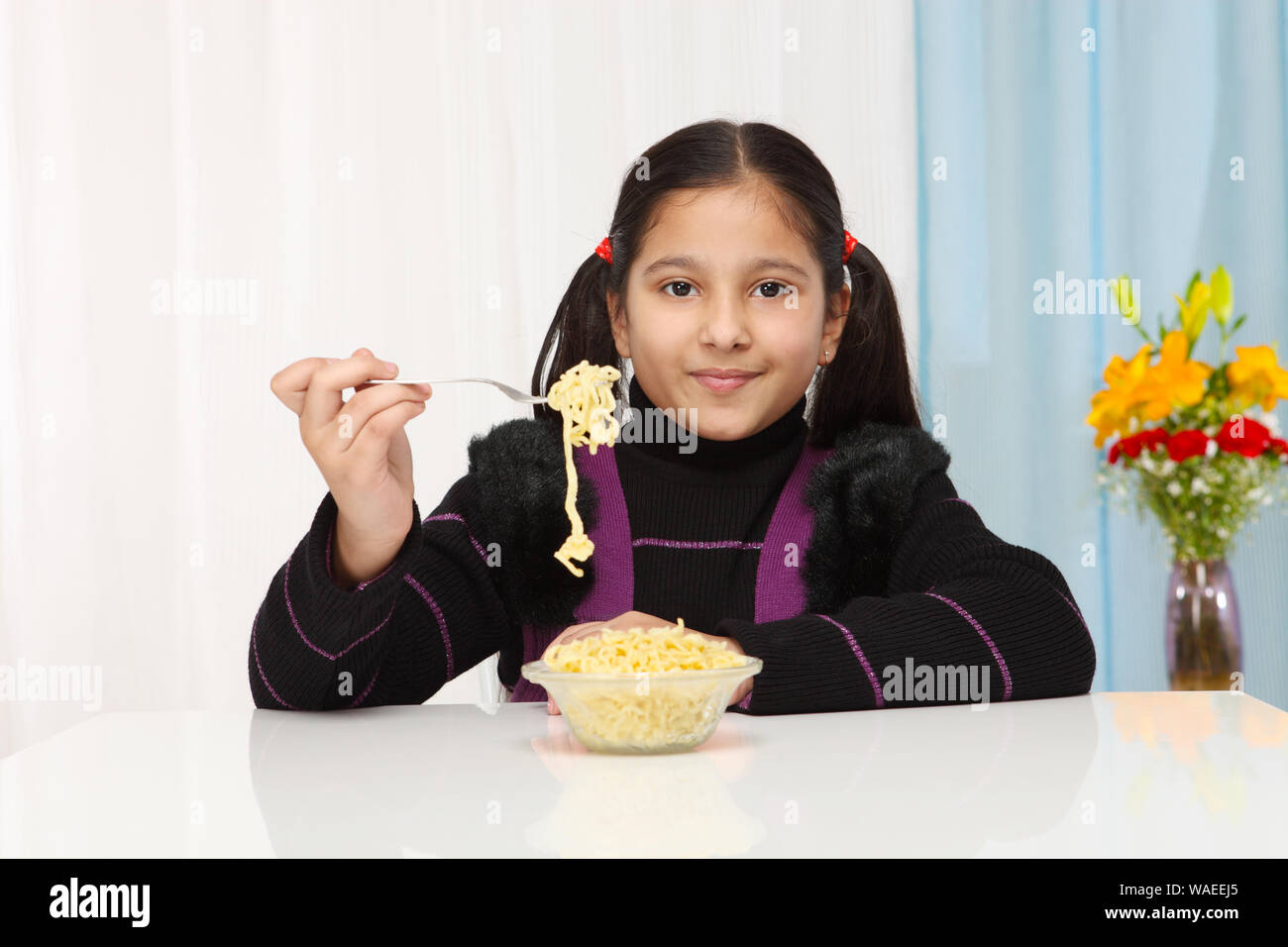 Girl eating noodles Stock Photo Alamy