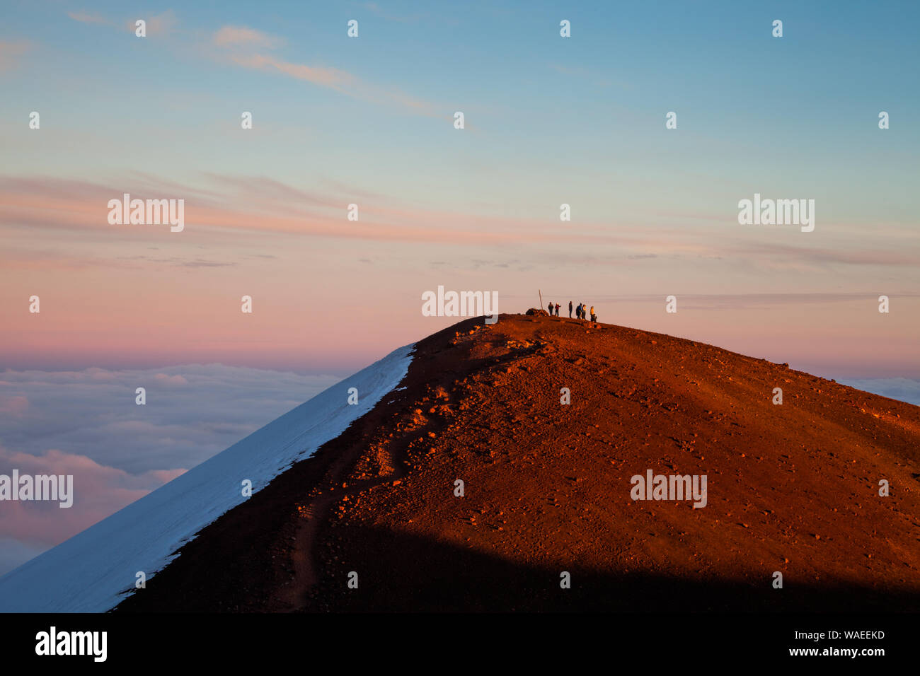 Native Hawaiian Shrine (Heiau) and its visitors atop a summit cone on Mauna Kea, Hawaii Stock Photo