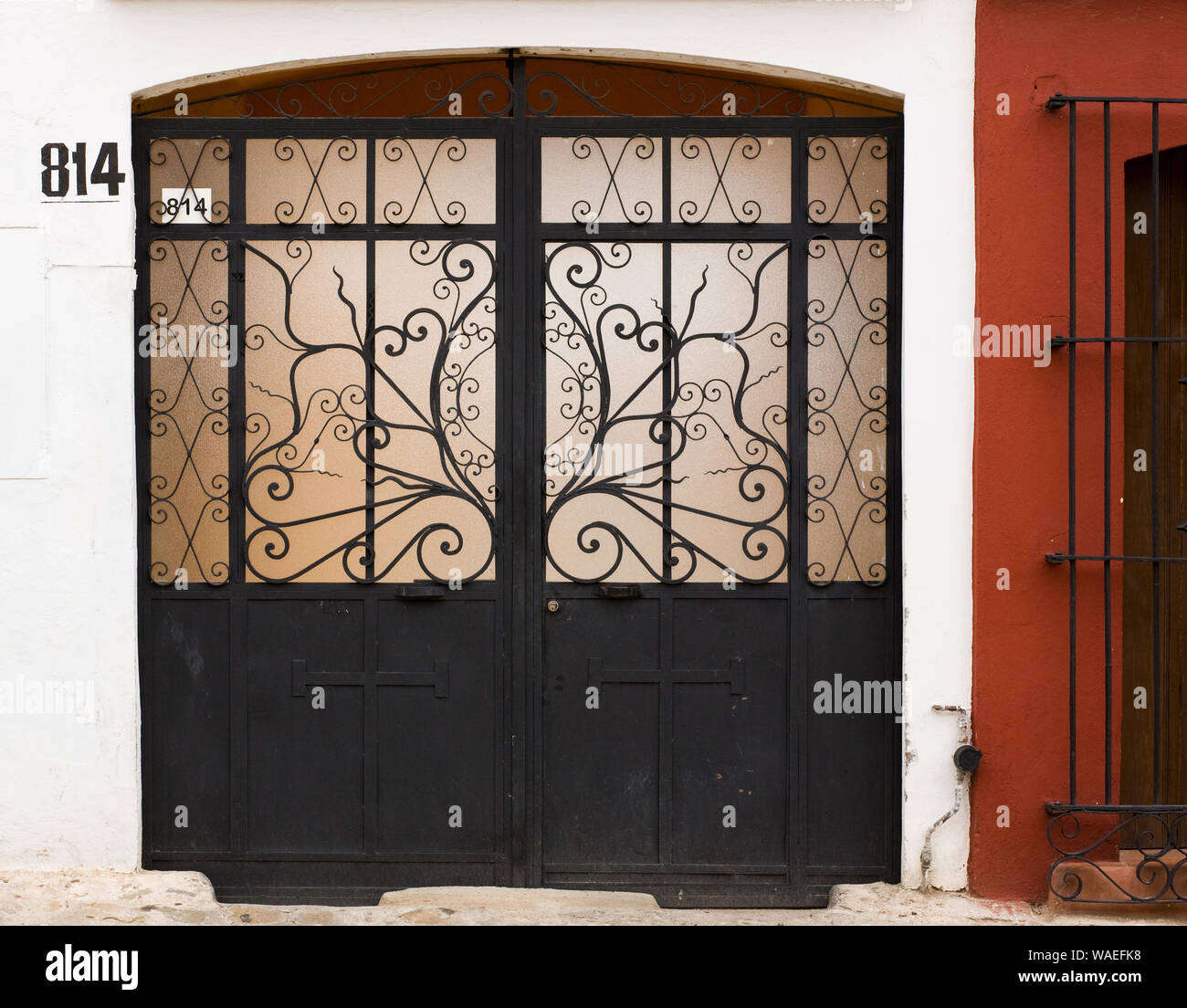 House home exterior with wrought iron garage doors, Oaxaca City, Oaxaca