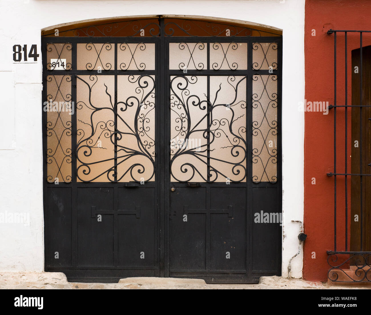 House home exterior with wrought iron garage doors, Oaxaca City, Oaxaca,  Mexico local architecture details Stock Photo - Alamy