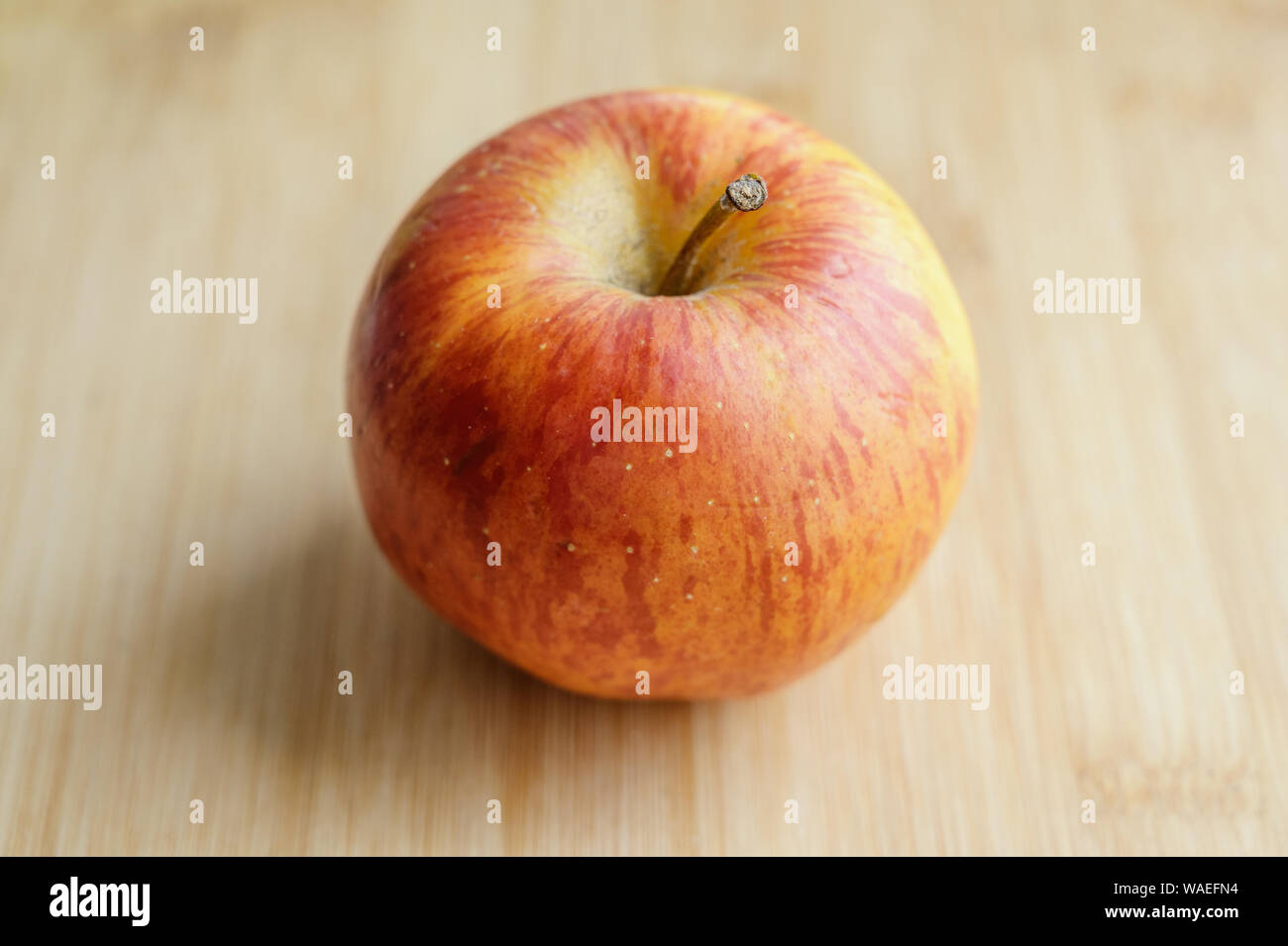 Fresh red apple on wooden table. Selective focus. Stock Photo