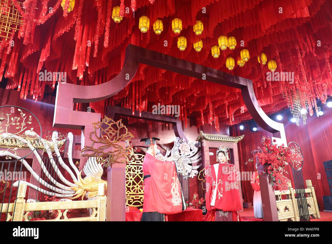 Anhui, Anhui, China. 20th Aug, 2019. Anhui, CHINA-A ''splendid'' Chinese wedding ceremony is successfully held in the grand banquet hall of Huayi hotel in Wuhu, Anhui province, Aug. 17, 2019.The theme of the Chinese wedding show highlights the Chinese wedding customs, attracting more than 100 couples and many wedding brands invited to participate in the scene, beautiful models wearing beautiful bridal suits on the runway very beautiful eyes. Credit: SIPA Asia/ZUMA Wire/Alamy Live News Stock Photo