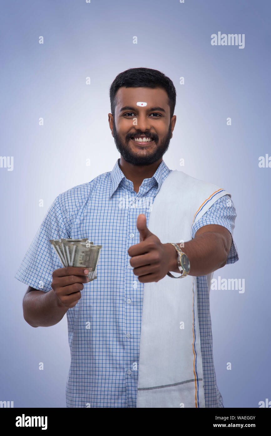 south indian man happy with his savings showing a thumbs up Stock Photo ...