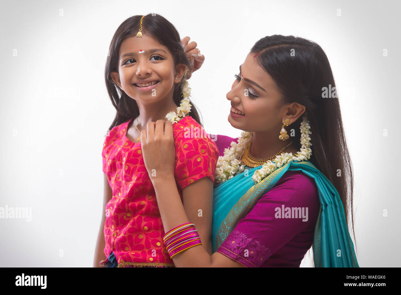 south indian woman putting gajra in her daughters hair Stock Photo - Alamy