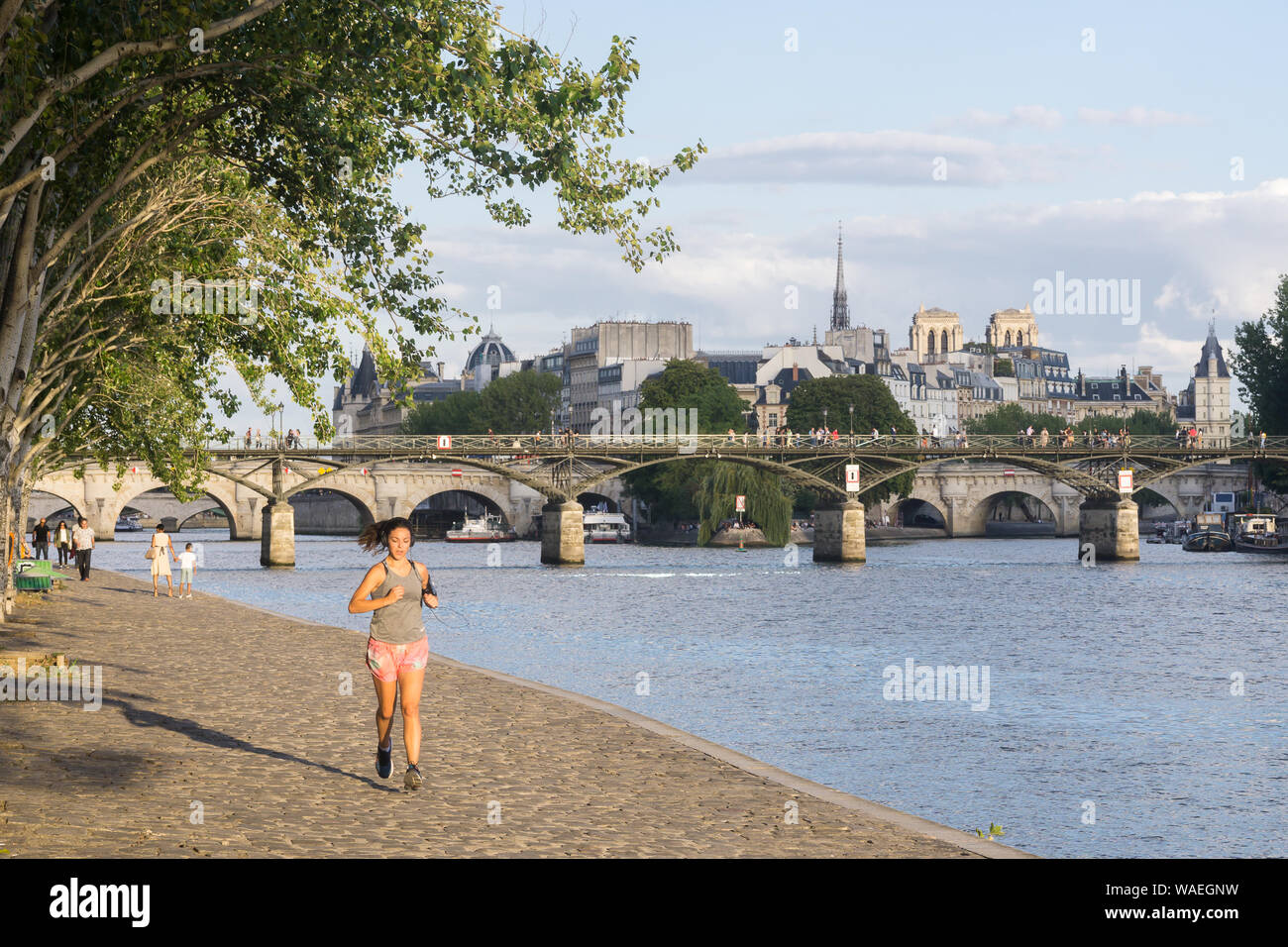 Paris Seine running - a girl running along the Seine River in Paris, France, Europe. Stock Photo
