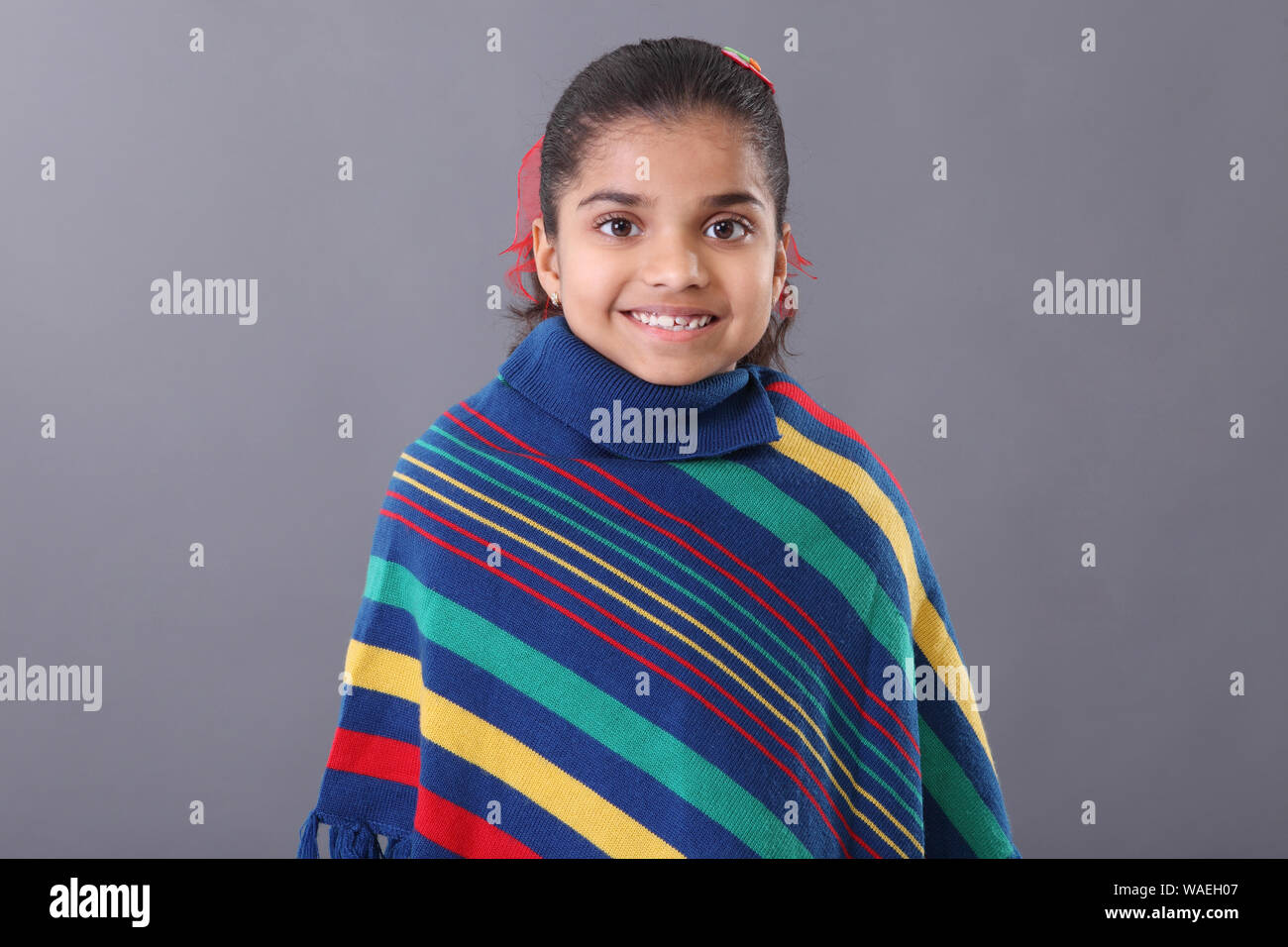 Schoolgirl holding an apple in a classroom Stock Photo - Alamy