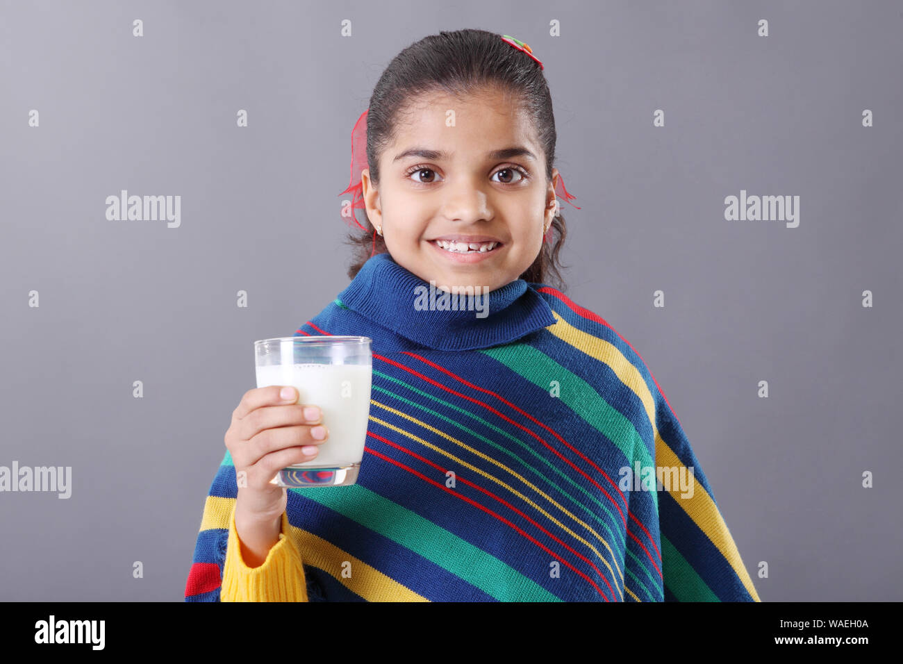 Schoolgirl looking in an apple in a classroom Stock Photo - Alamy