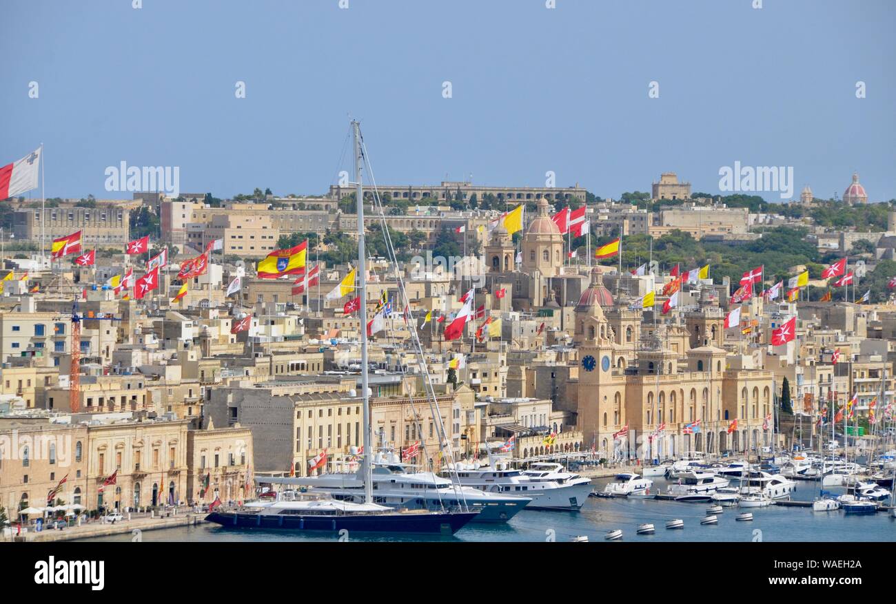 view of old port of valletta with flying flags malta Stock Photo