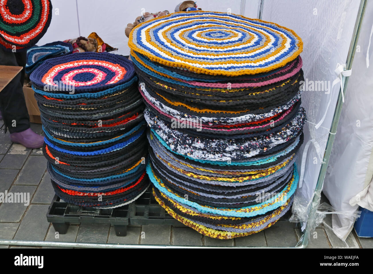 Homemade round knitted rugs that are placed near the door are sold on ...