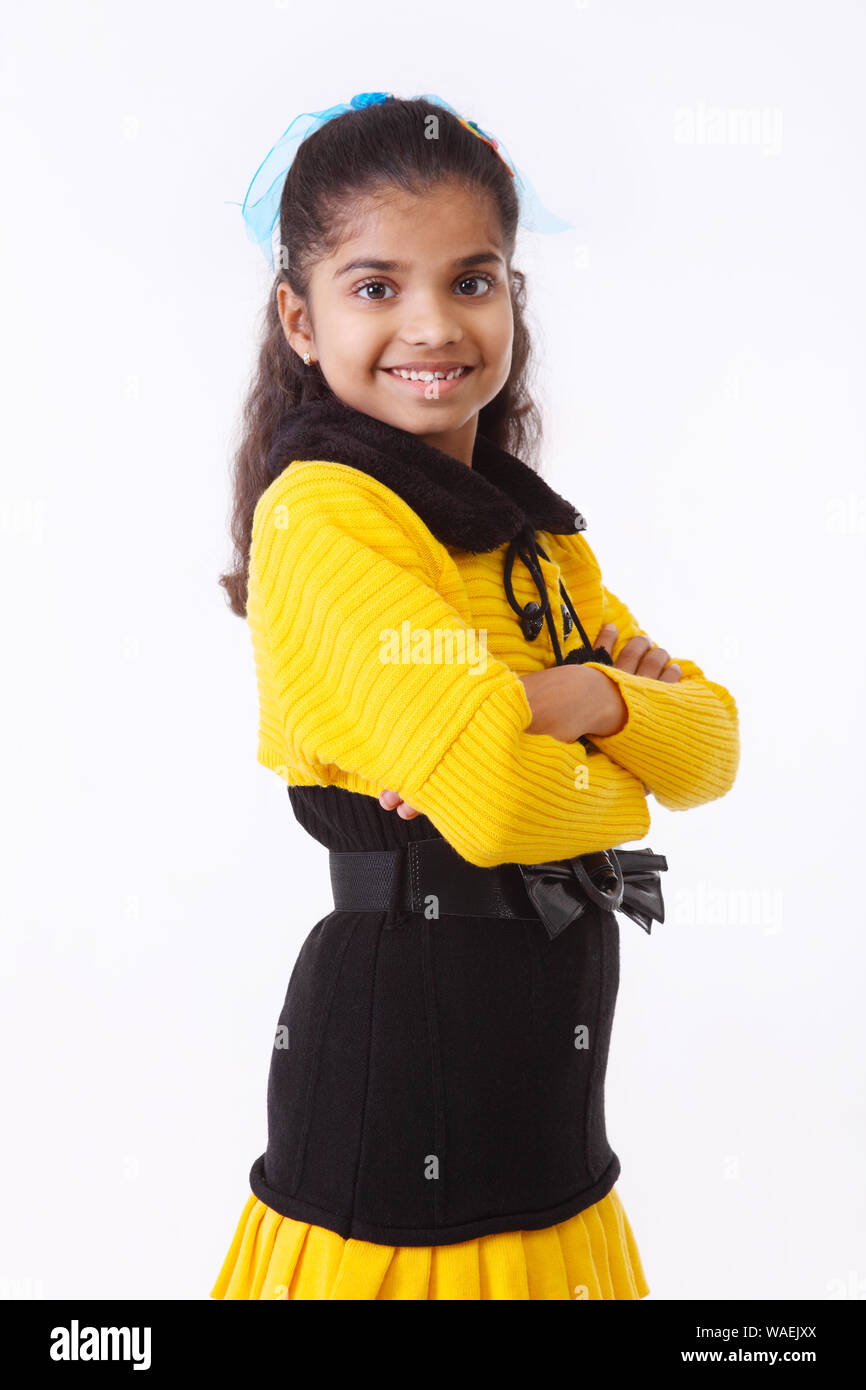 Girl standing with her arms crossed and smiling Stock Photo - Alamy