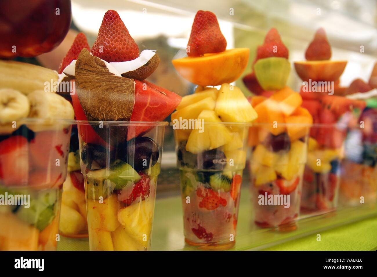 plastic cup of fresh cut fruit. Delicious fruit salad arranged in