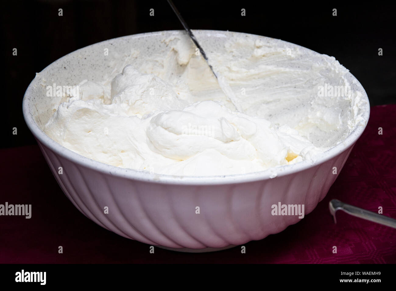 a white bowl full of fresh whipped cream from  alocal farmers market in the mountains. Stock Photo