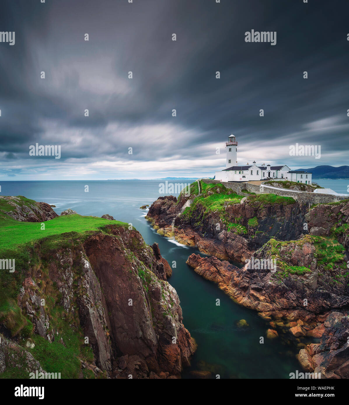 Dark clouds move over the Fanad Head Lighthouse in Ireland Stock Photo