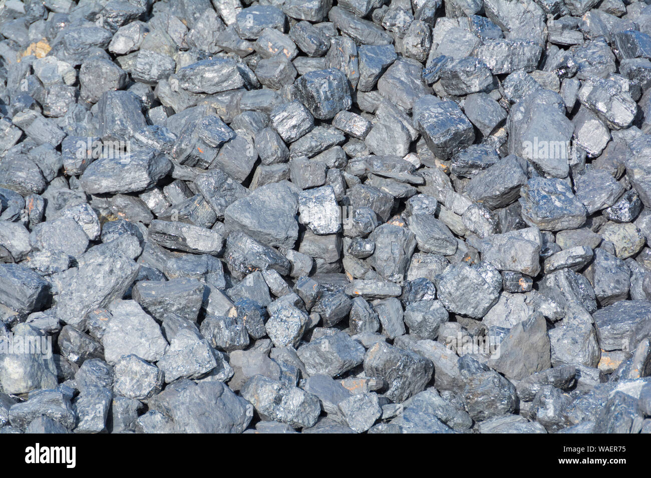 A large heap of coal alongside a railway siding in the UK Stock Photo