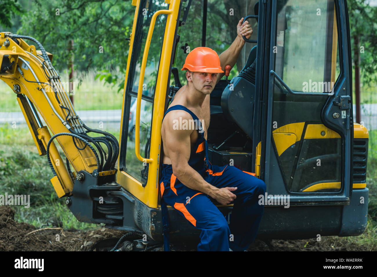 Driver concept. Excavator driver on construction site. Man driver at