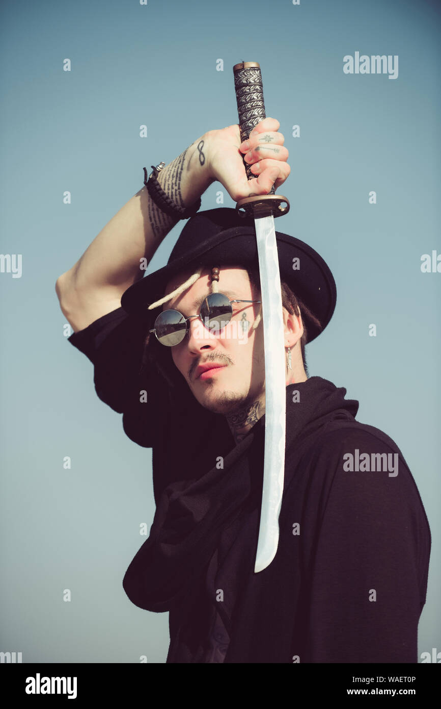 Warrior in sunglasses, black hat and clothes Stock Photo