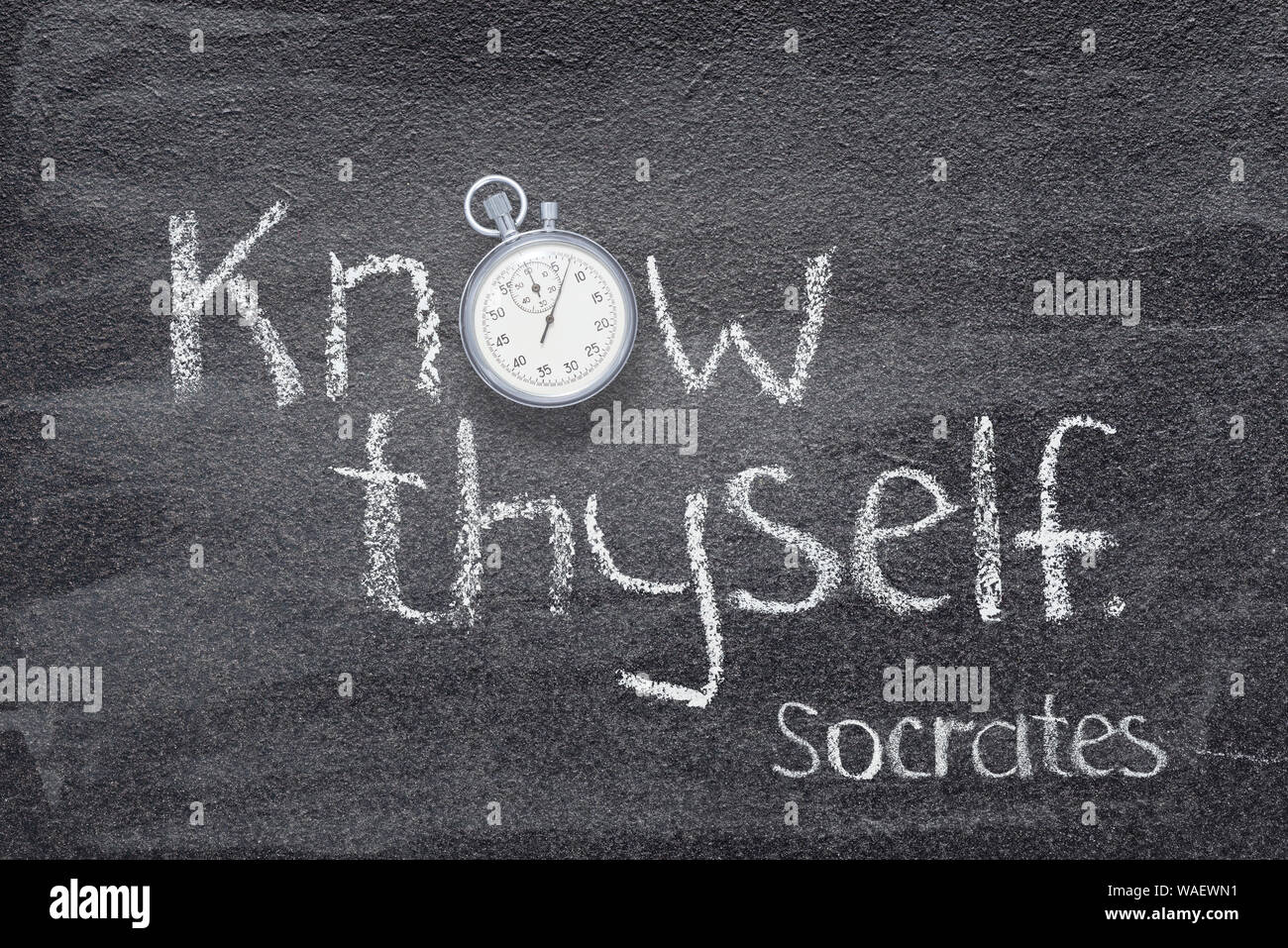 Know thyself - quote of ancient Greek philosopher Socrates written on chalkboard with vintage stopwatch instead of O Stock Photo