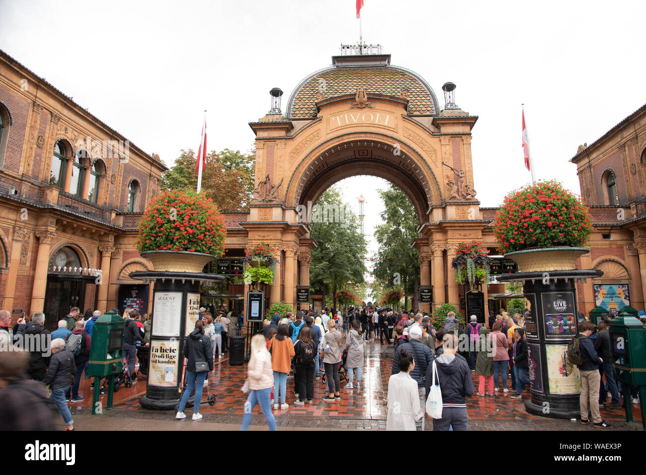 Visitors walking through the portal of Tivoli gardens in Copenhagen, Denmark, August 16, 2019 Stock Photo
