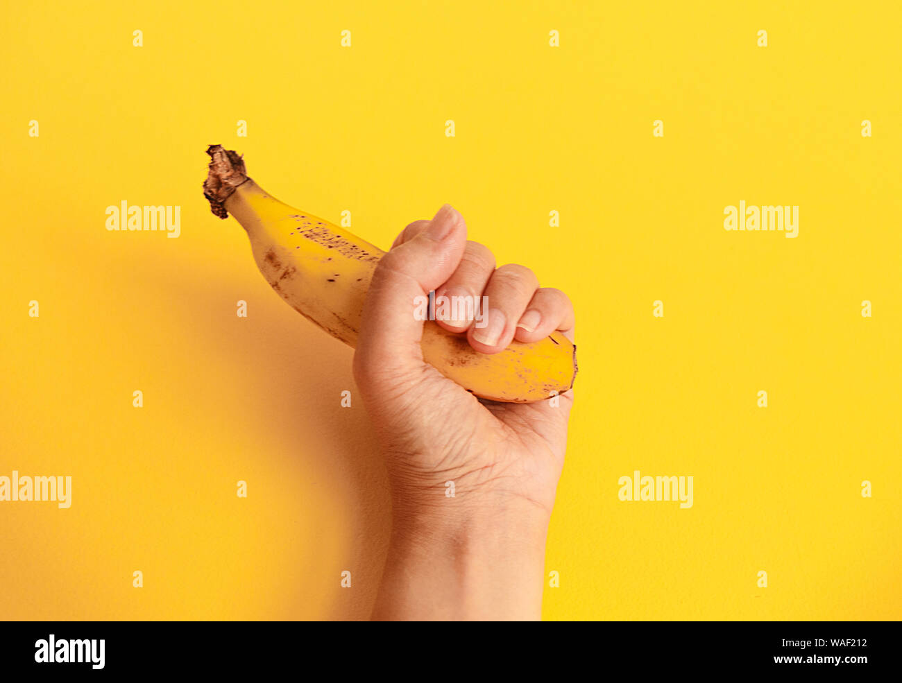 banana on yellow wall Stock Photo Alamy