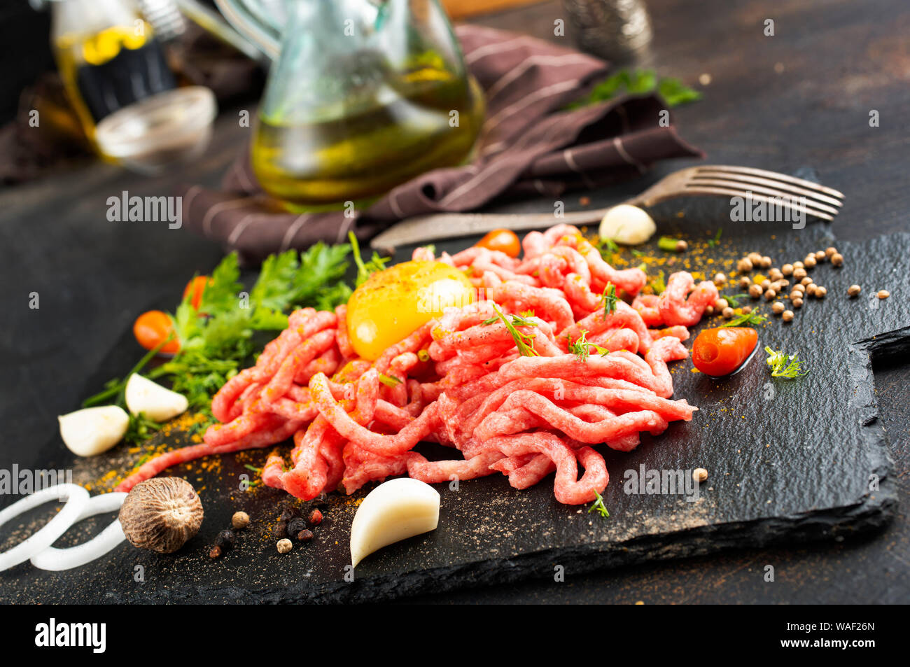 Raw minced meat with egg, herbs and spices Stock Photo Alamy