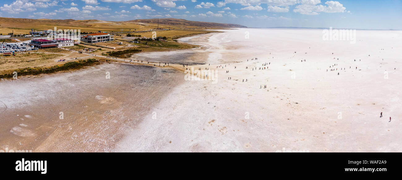 Aerial view of Lake Tuz, Tuz Golu. Salt Lake. White salt water. It is the second largest lake in Turkey. People standing in the middle of the lake Stock Photo