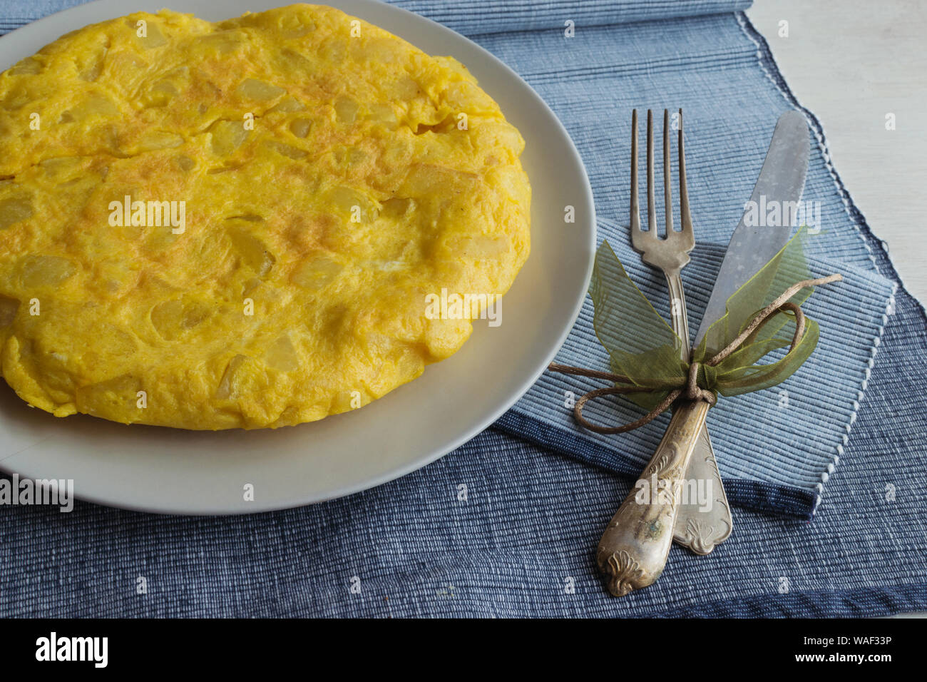 spanish omelette called tortilla de patatas with vintage cutlery Stock Photo