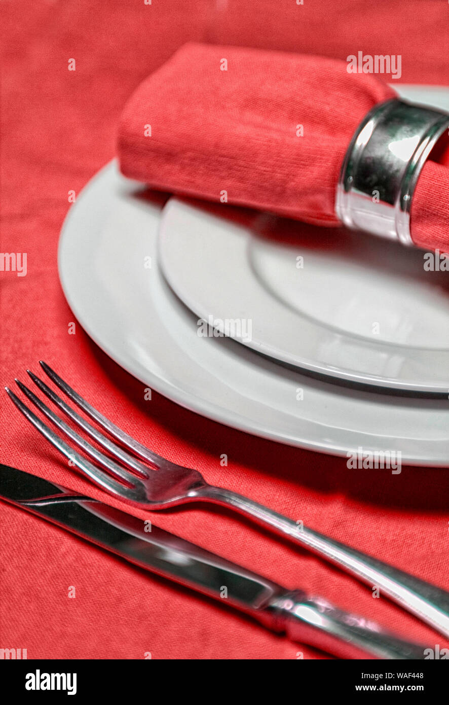 table setting with plates, napkin, silverware in a bright red color Stock Photo Alamy