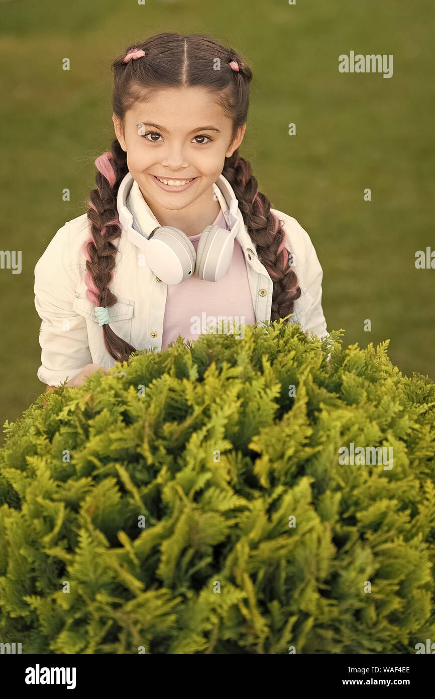 Secrets to raising happy child. Girl cute kid green grass background