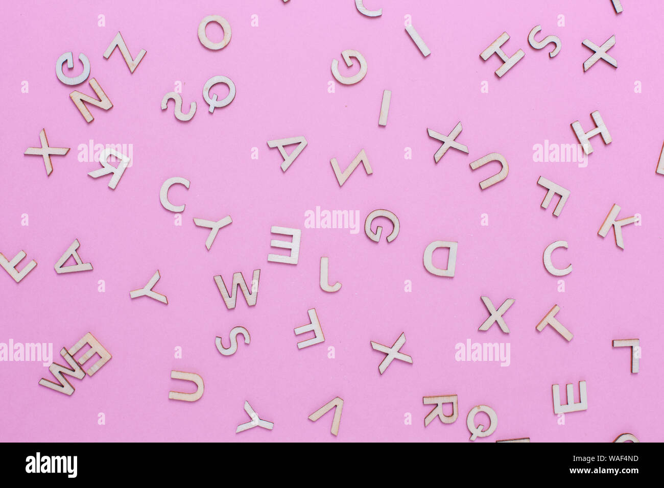 Wooden ABC alphabet letters on pink background Stock Photo