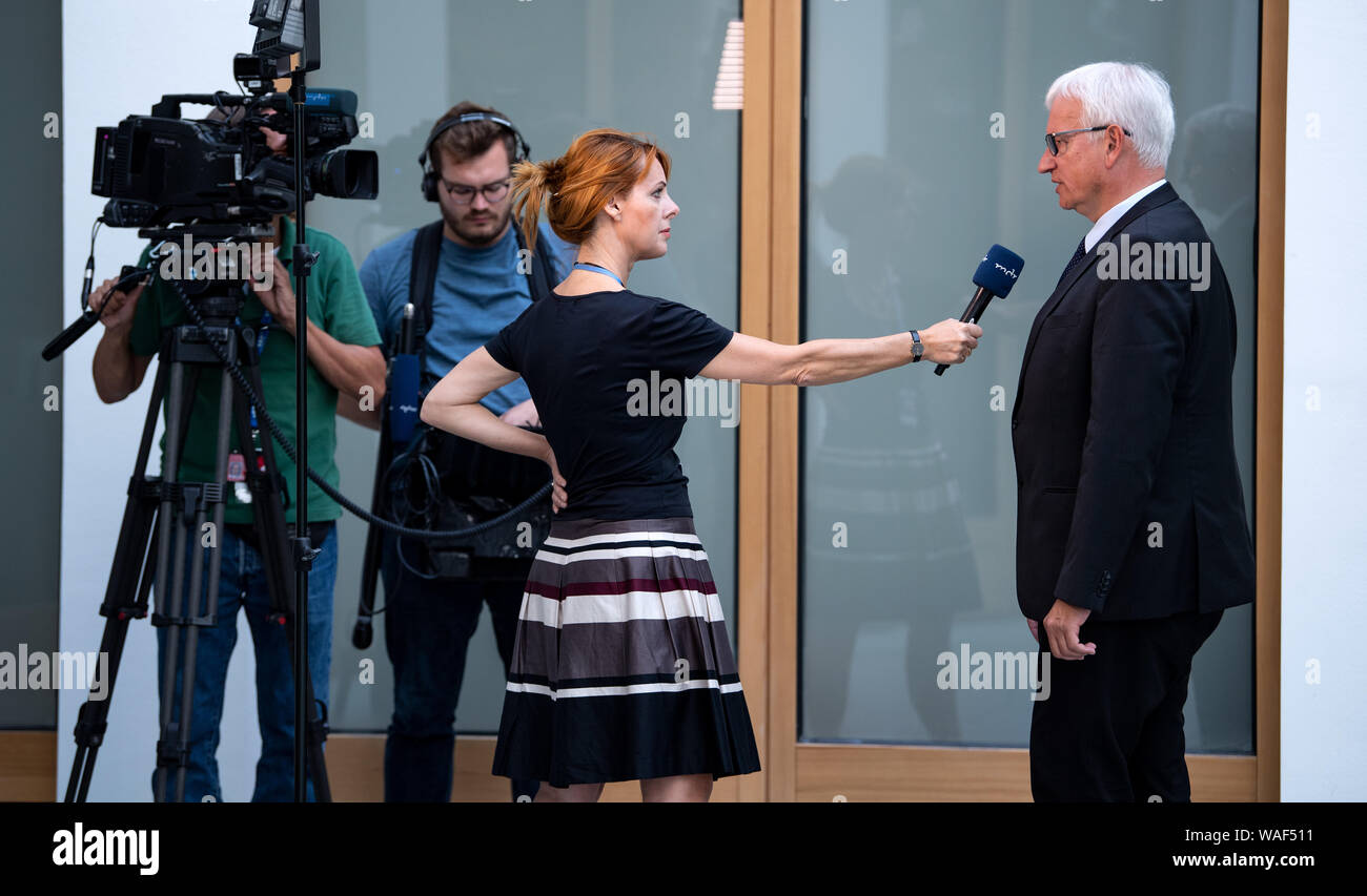 Berlin, Germany. 20th Aug, 2019. Jürgen Resch, Managing Director of Deutsche Umwelthilfe (DUH), is interviewed by a television team on the occasion of a press conference of Deutsche Umwelthilfe on the future of the automotive industry in Germany at the Haus der Bundespressekonferenz. Credit: Bernd von Jutrczenka/dpa/Alamy Live News Stock Photo