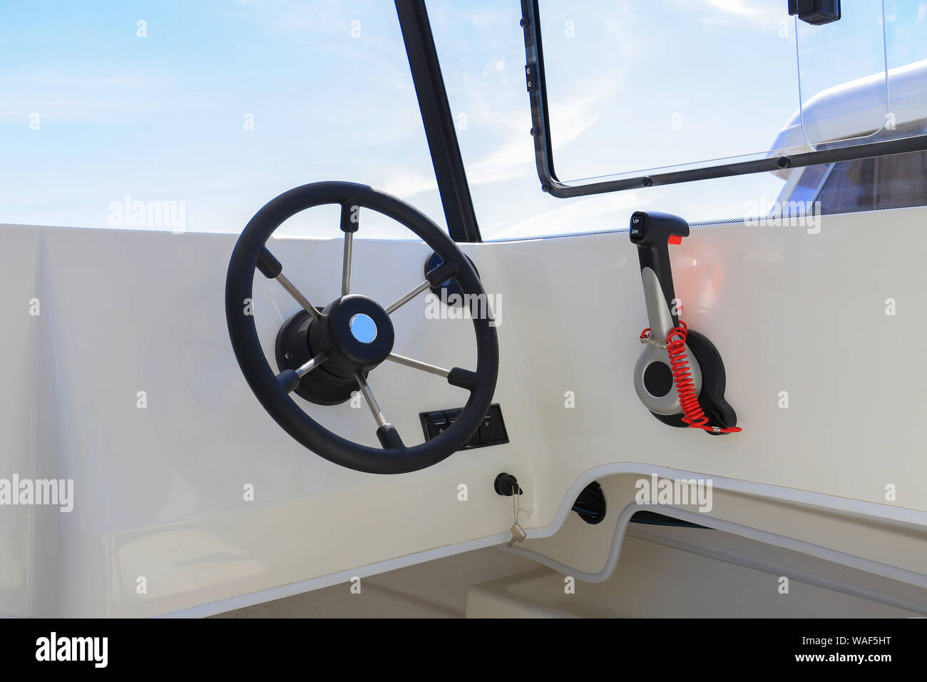 Motor boat steering wheel with throttle control in cockpit Stock Photo