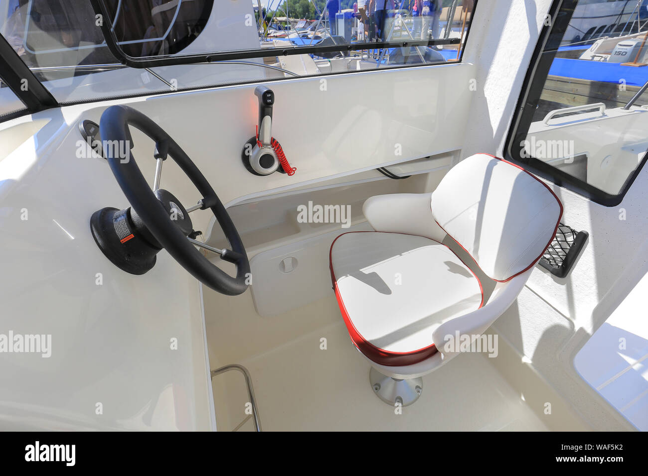 Motor boat steering wheel with throttle control in cockpit Stock Photo