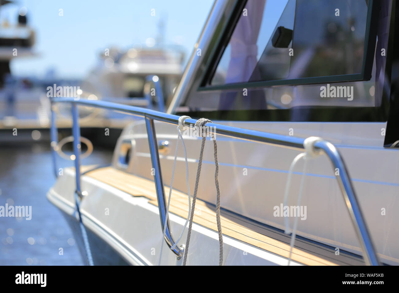 Mooring knot on the guard rails sailing yacht in marina Stock Photo