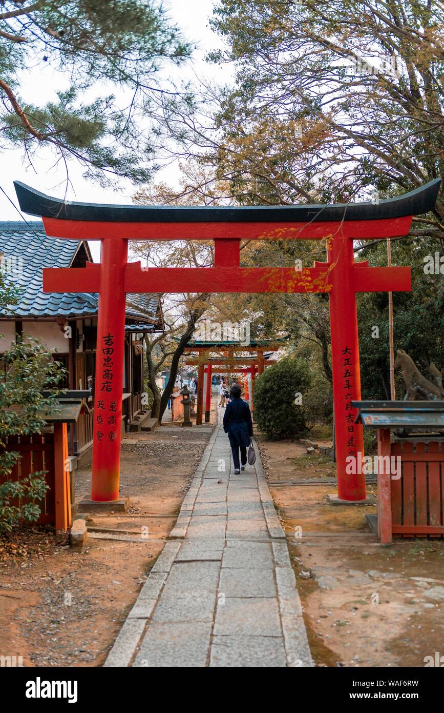 Japanese runs between Torii gates, Yoshida shrine, Kyoto, Japan Stock Photo