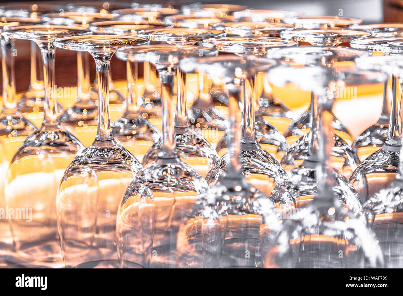 Many upturned wine glasses on table close up Stock Photo