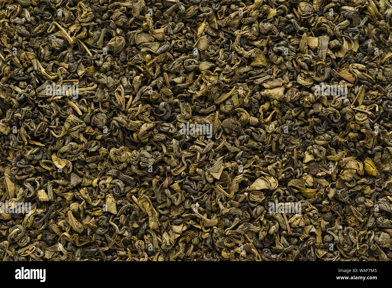 Dry oolong tea leaves as a background. Fermented Chinese tea shot from above. Stock Photo