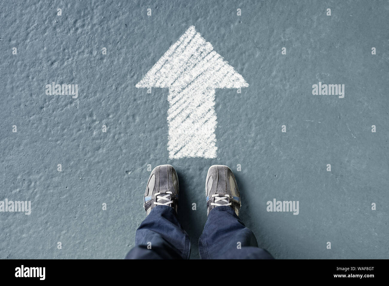 Man standing with forward ahead direction arrow Stock Photo