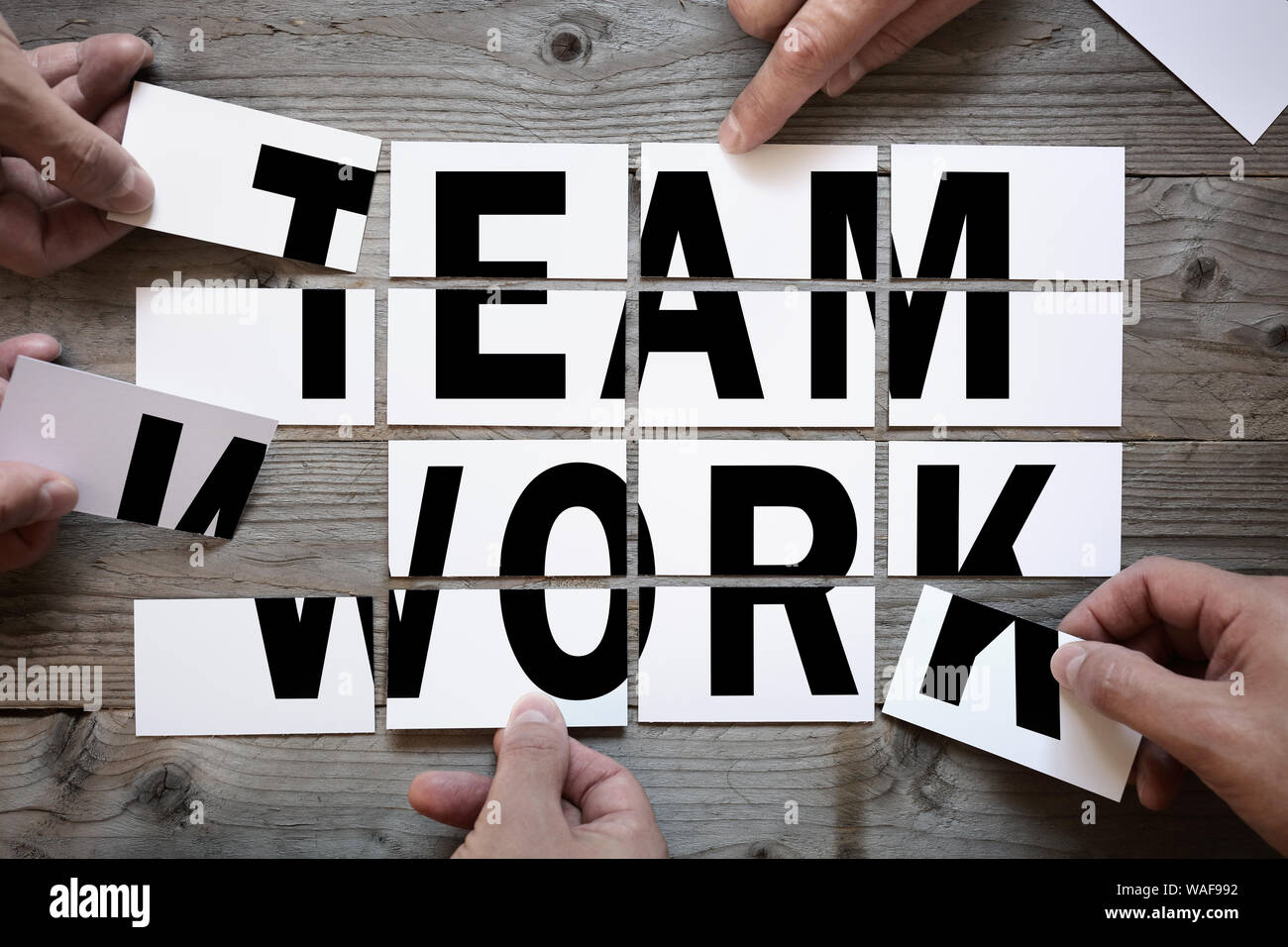 Business team brainstorming - teamwork or solution with word team work on cards Stock Photo
